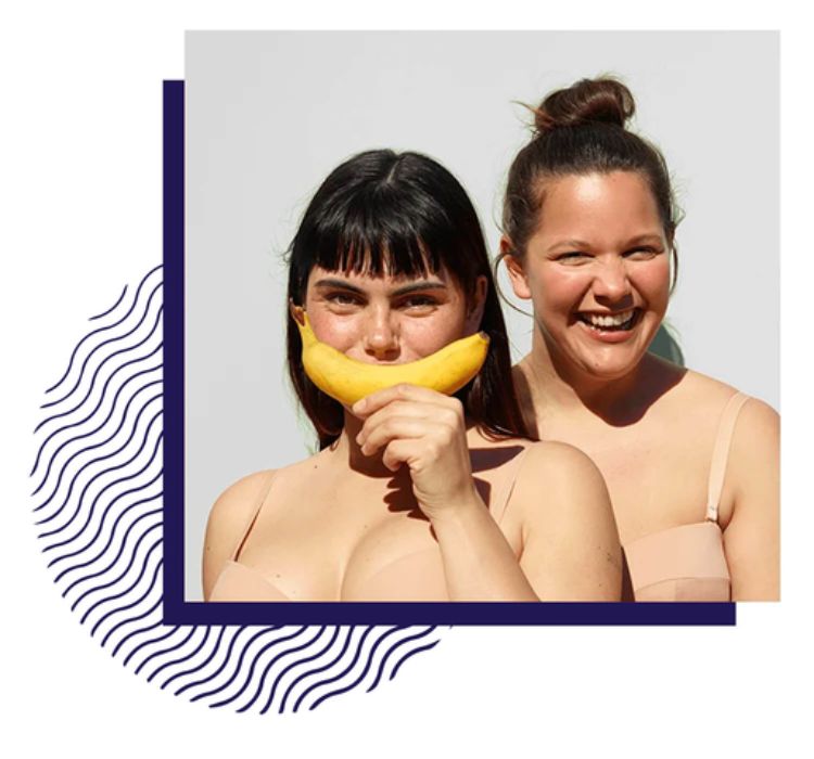 Women smiling with a banana