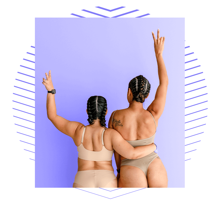 Two women with their arms raised